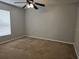 Bedroom with neutral paint, carpeting, ceiling fan, and a window for natural light at 36 Inconnu Dr, Poinciana, FL 34759