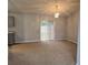 Dining area with neutral carpet, chandelier, and sliding door access to the screened back porch at 36 Inconnu Dr, Poinciana, FL 34759