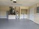 Garage area with painted floor, laundry hook ups, and storage cabinet at 36 Inconnu Dr, Poinciana, FL 34759