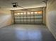 Garage with epoxy floor and garage door at 36 Inconnu Dr, Poinciana, FL 34759