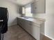 Well-equipped kitchen featuring sleek gray cabinetry, stylish countertops, and a stainless steel sink at 36 Inconnu Dr, Poinciana, FL 34759