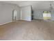 Spacious living room with neutral carpet and paint leading to a screened back porch at 36 Inconnu Dr, Poinciana, FL 34759