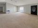 Expansive living room featuring plush tan carpeting, natural light and modern interior design at 36 Inconnu Dr, Poinciana, FL 34759