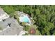 An aerial view of a community pool and playground surrounded by trees at 4004 Santa Maria Dr # 108, Kissimmee, FL 34741