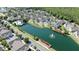Stunning aerial view of townhomes, a sparkling pool, and a tranquil pond with fountain at 4004 Santa Maria Dr # 108, Kissimmee, FL 34741