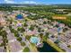 Community aerial view featuring pool, pond and clubhouse amidst lush landscaping at 4004 Santa Maria Dr # 108, Kissimmee, FL 34741
