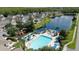A scenic aerial view showcasing the pool, lake, playground and neighborhood at 4004 Santa Maria Dr # 108, Kissimmee, FL 34741