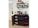 Home bar area featuring wine and coffee storage with decorative shelving, perfect for entertaining at 4004 Santa Maria Dr # 108, Kissimmee, FL 34741