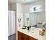 Bathroom featuring a well-lit mirror, modern fixtures, and a convenient hairdryer at 4004 Santa Maria Dr # 108, Kissimmee, FL 34741