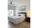 Well-lit bedroom with a comfortable bed, stylish bedding, and an ocean-themed art piece at 4004 Santa Maria Dr # 108, Kissimmee, FL 34741