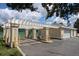 Community car wash area with washing equipment and parking spots adjacent to tennis courts and the clubhouse at 4004 Santa Maria Dr # 108, Kissimmee, FL 34741