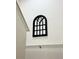 A decorative gothic-style window mirror adds architectural interest to the wall at 4004 Santa Maria Dr # 108, Kissimmee, FL 34741