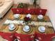Festive dining room with seating for six, adorned with snowflake chair covers and elegant tableware at 4004 Santa Maria Dr # 108, Kissimmee, FL 34741