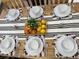 Inviting dining table set for six, featuring playful Mickey Mouse-themed placemats and a refreshing citrus centerpiece at 4004 Santa Maria Dr # 108, Kissimmee, FL 34741