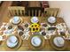 Festive dining table arrangement featuring gold chargers, elegant tableware, and charming fall-themed decorations at 4004 Santa Maria Dr # 108, Kissimmee, FL 34741