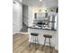 Inviting kitchen with white cabinets, stainless steel appliances, and a stylish breakfast bar with modern stools at 4004 Santa Maria Dr # 108, Kissimmee, FL 34741