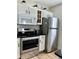 Well-equipped kitchen with stainless steel appliances, white cabinetry, and modern black countertops at 4004 Santa Maria Dr # 108, Kissimmee, FL 34741