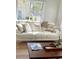 Comfortable living room featuring a white sofa, stylish pillows, and a modern coffee table with decorative accents at 4004 Santa Maria Dr # 108, Kissimmee, FL 34741