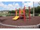 A colorful playground with a slide and climbing structure on a safety-mulched surface for play at 4004 Santa Maria Dr # 108, Kissimmee, FL 34741
