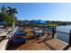 Pool deck with numerous seating options alongside a lake and a clear blue sky, ideal for relaxing at 4004 Santa Maria Dr # 108, Kissimmee, FL 34741
