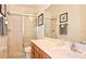 Bathroom featuring a glass door shower, large mirror and neutral tones at 4072 Oaktree Dr, Davenport, FL 33837