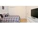 Comfortable bedroom featuring a plaid-patterned bed, a white dresser with a television on top, and a closet at 4072 Oaktree Dr, Davenport, FL 33837