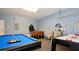 Entertaining game room featuring a pool table, foosball table, and a superhero-themed painted wall at 4072 Oaktree Dr, Davenport, FL 33837