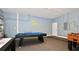 Entertaining game room featuring a pool table, foosball table, and Batman-themed wall art at 4072 Oaktree Dr, Davenport, FL 33837