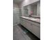 Double sink bathroom with a glass enclosed shower at 4147 Sherlock Ct, Orlando, FL 32824