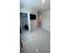 This bedroom features marble floors, a mounted TV, closet, and door to another room at 4147 Sherlock Ct, Orlando, FL 32824