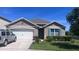 Charming one-story home featuring a two-car garage, well-maintained lawn, and neutral color palette at 4147 Sherlock Ct, Orlando, FL 32824