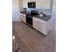 Bright kitchen features white cabinets, granite countertops, and stainless steel appliances at 4147 Sherlock Ct, Orlando, FL 32824