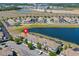 Community aerial showcasing a large lake, mature trees and multiple buildings at 4907 Romeo Cir, Kissimmee, FL 34746