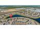 Wide aerial shot of the community, showcasing the serene lake and mature trees at 4907 Romeo Cir, Kissimmee, FL 34746