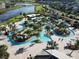 Aerial view of a community featuring a pool, lazy river, putt-putt golf, and water slides at 4907 Romeo Cir, Kissimmee, FL 34746