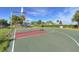 Well-maintained basketball court surrounded by palm trees, ideal for friendly games and outdoor activities at 4907 Romeo Cir, Kissimmee, FL 34746