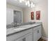 Bright bathroom featuring a granite countertop, double vanity, and neutral wall color at 4907 Romeo Cir, Kissimmee, FL 34746