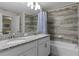 Bright bathroom featuring a granite countertop, double vanity, and tiled shower/tub combo at 4907 Romeo Cir, Kissimmee, FL 34746