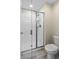 This bathroom features a glass shower stall, neutral walls, tiled floors and standard toilet at 4907 Romeo Cir, Kissimmee, FL 34746