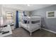 This bedroom features bunk beds, a bedside table, neutral walls and blue decorative pillows and curtains at 4907 Romeo Cir, Kissimmee, FL 34746