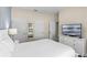 Bright bedroom features a television, dresser, and a comfortable queen-sized bed at 4907 Romeo Cir, Kissimmee, FL 34746