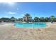 Expansive community pool surrounded by a large sun deck, palm trees, and attractive landscaping at 4907 Romeo Cir, Kissimmee, FL 34746
