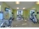 Bright community gym with fitness equipment, including weights, treadmill, and leg press machine at 4907 Romeo Cir, Kissimmee, FL 34746