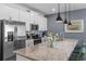 Bright kitchen boasting stainless steel appliances, granite counters, and mosaic backsplash at 4907 Romeo Cir, Kissimmee, FL 34746