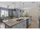 Open-concept kitchen with island seating flows into the living and dining areas at 4907 Romeo Cir, Kissimmee, FL 34746