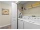 This laundry room features a full size washer and dryer, storage, neutral walls and carpeted floors at 4907 Romeo Cir, Kissimmee, FL 34746