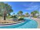 The community's lazy river is surrounded by palm trees, mini golf and upscale landscaping at 4907 Romeo Cir, Kissimmee, FL 34746