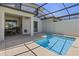 This backyard features a private pool with a screened in lanai and dining table on the patio at 4907 Romeo Cir, Kissimmee, FL 34746