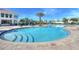 Community pool offering a refreshing retreat and a place to relax with palm tree views at 4907 Romeo Cir, Kissimmee, FL 34746