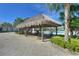 Outdoor tiki bar offers shaded seating near a community pool with palm trees and lush landscaping at 4907 Romeo Cir, Kissimmee, FL 34746
